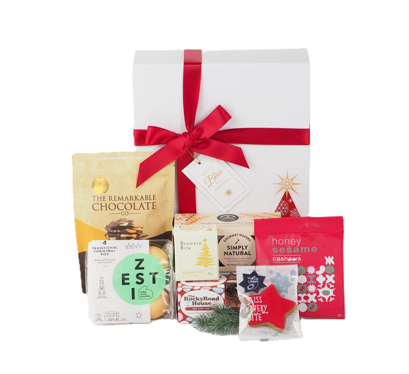 Celebrate the magic of Christmas - Filled with festive favourites - Elegantly presented in a crisp white gift box - Red satin ribbon - perfect for family, friends, colleagues, or corporate gifting.
